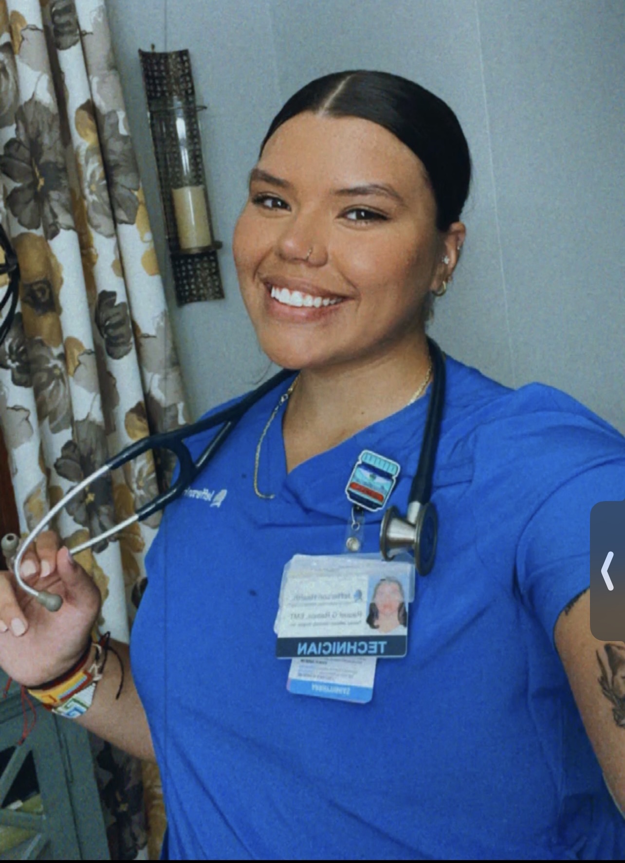Raquel Ramos, BS health sciences ’23, wearing blue scrubs holding stethoscope. 